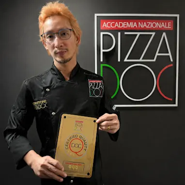 Boss showing Pizza DOC Certificate